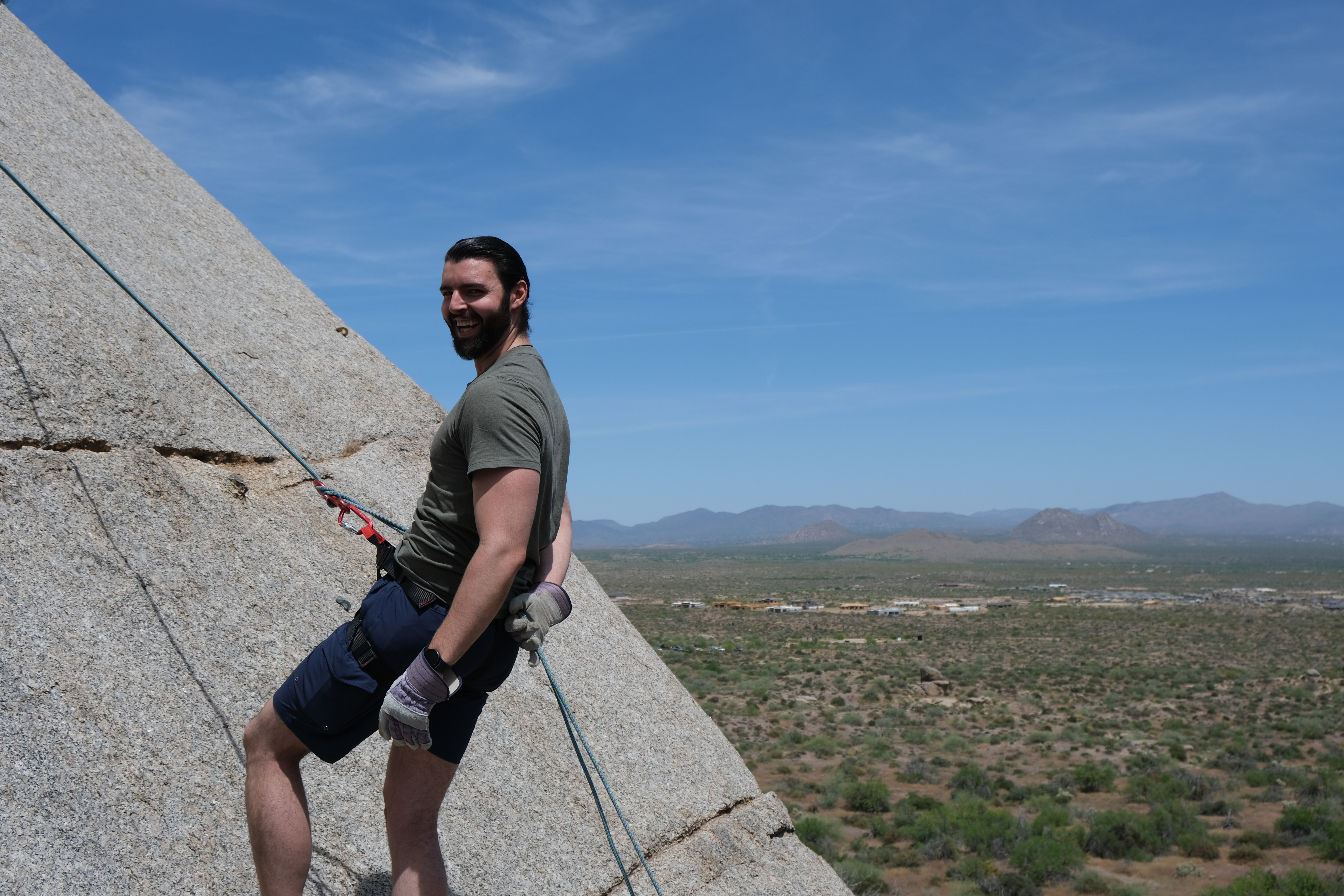 Travis Jones rock climbing in Arizona desert landscape